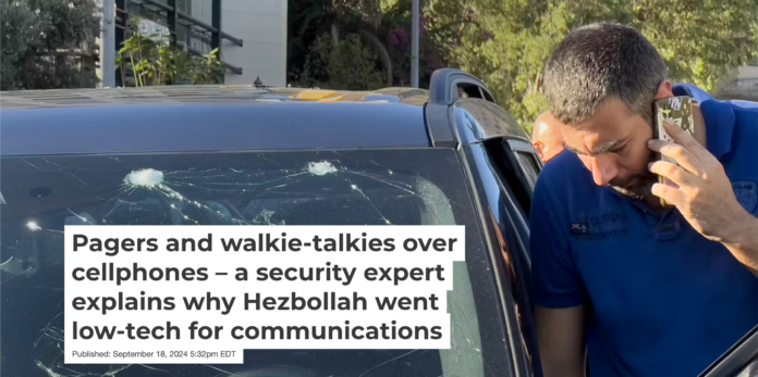 A police officer examines a damaged car after thousands of pagers exploded simultaneously across Lebanon on Sept. 17, 2024. AP Photo/Hussein Malla